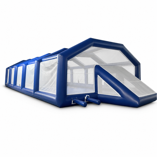 Covered commercial inflatable soccer field with perimeter walls and netting on white background